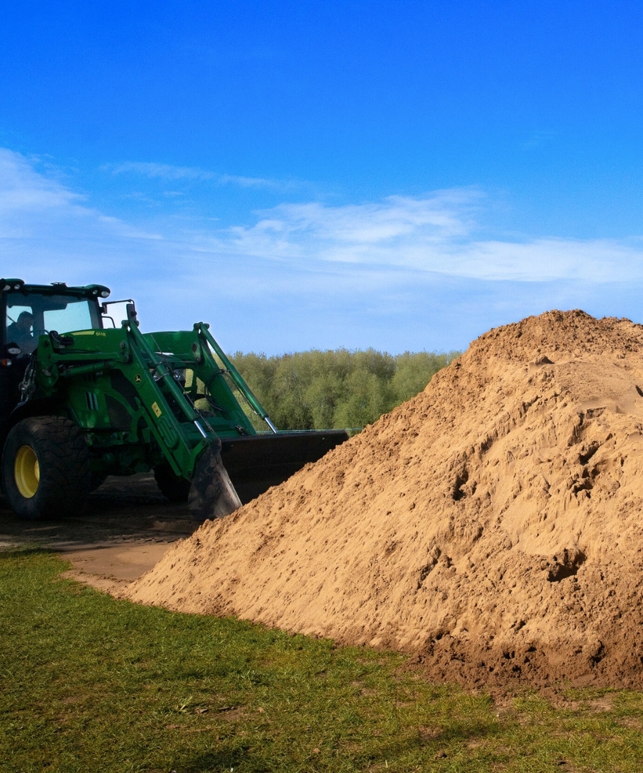 digger moving mounds of sand