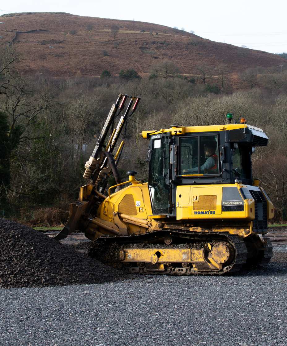 digger on site moving stone